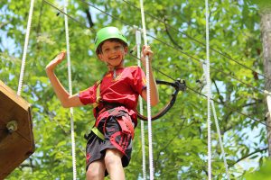 young boy on high ropes course