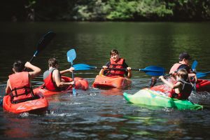 boys kayaking in lake