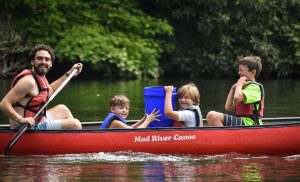 boys with counselor in canoe