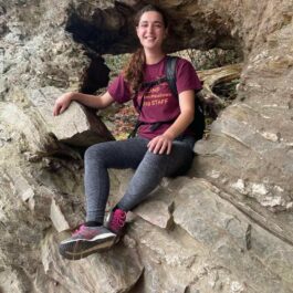 girl sitting on rock