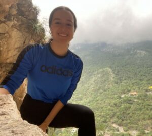 girl hiking rock