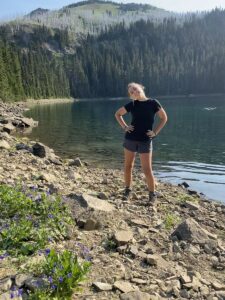 girl standing in front of lake