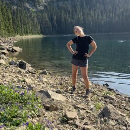 girl standing in front of lake